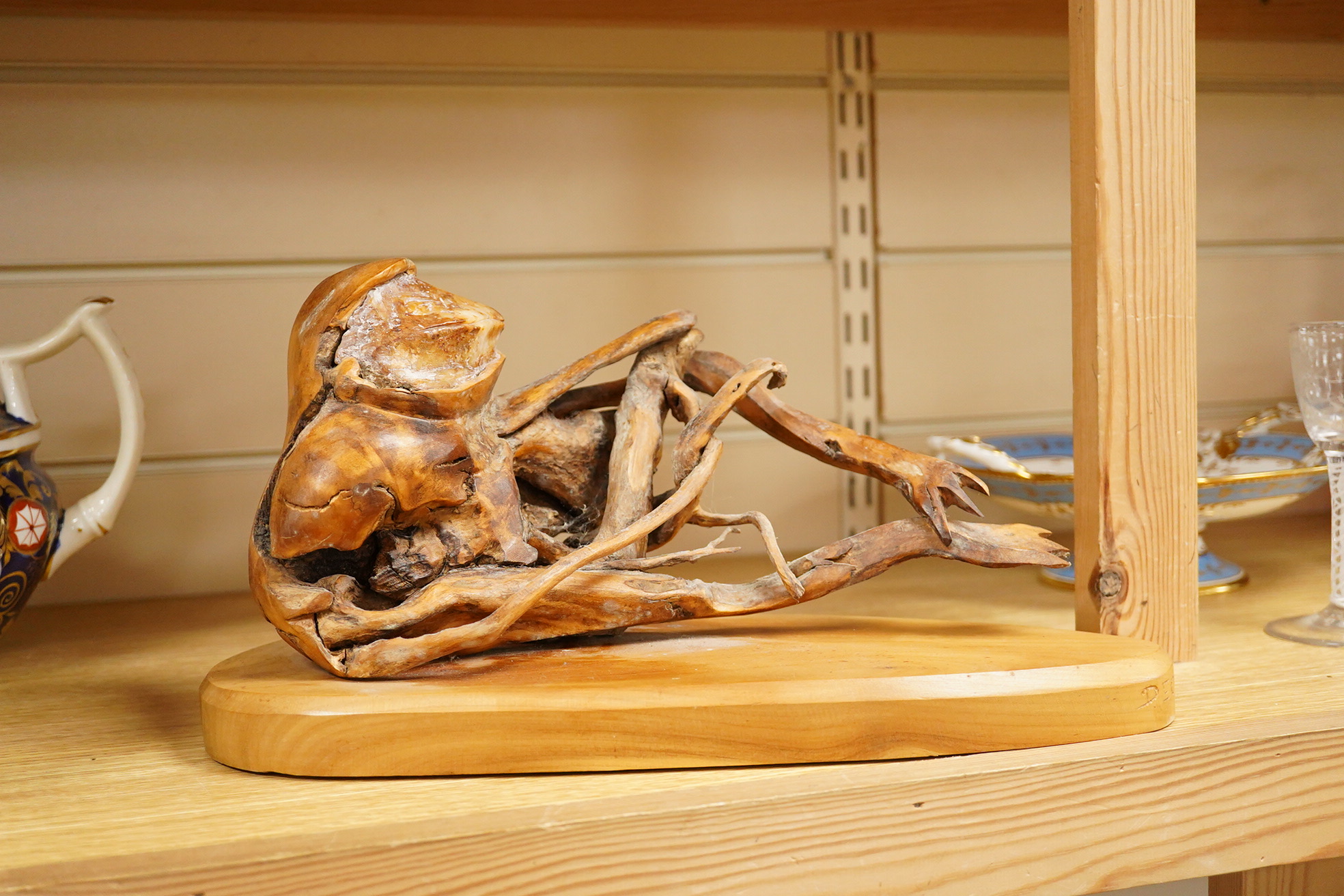 Pierre Decorse (b.1953), a wooden sculpture of a reclining frog-like figure, base 34cms long